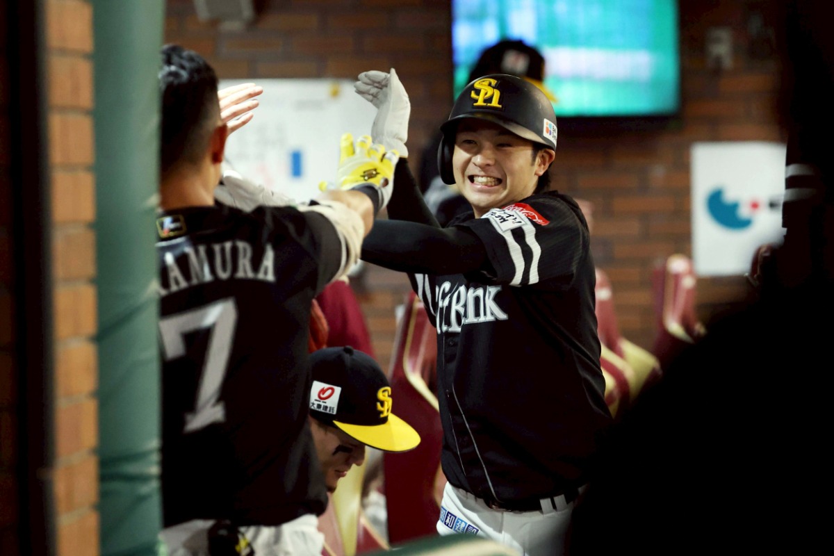 ベンチでハイタッチする川瀬晃【写真：栗木一考】