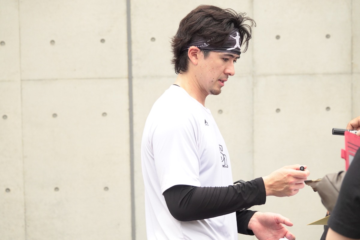 リハビリ期間中、ファンにサインを書く上沢直之【写真：竹村岳】